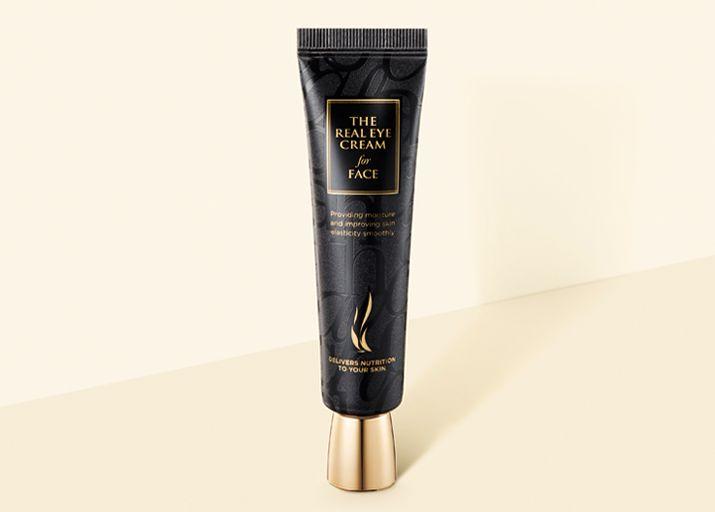 AHC The Real Eye Cream for Face tube on a beige background representing popular Korean eye cream suitable for facial application.